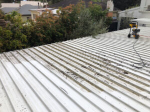 Roof being pressure cleaned